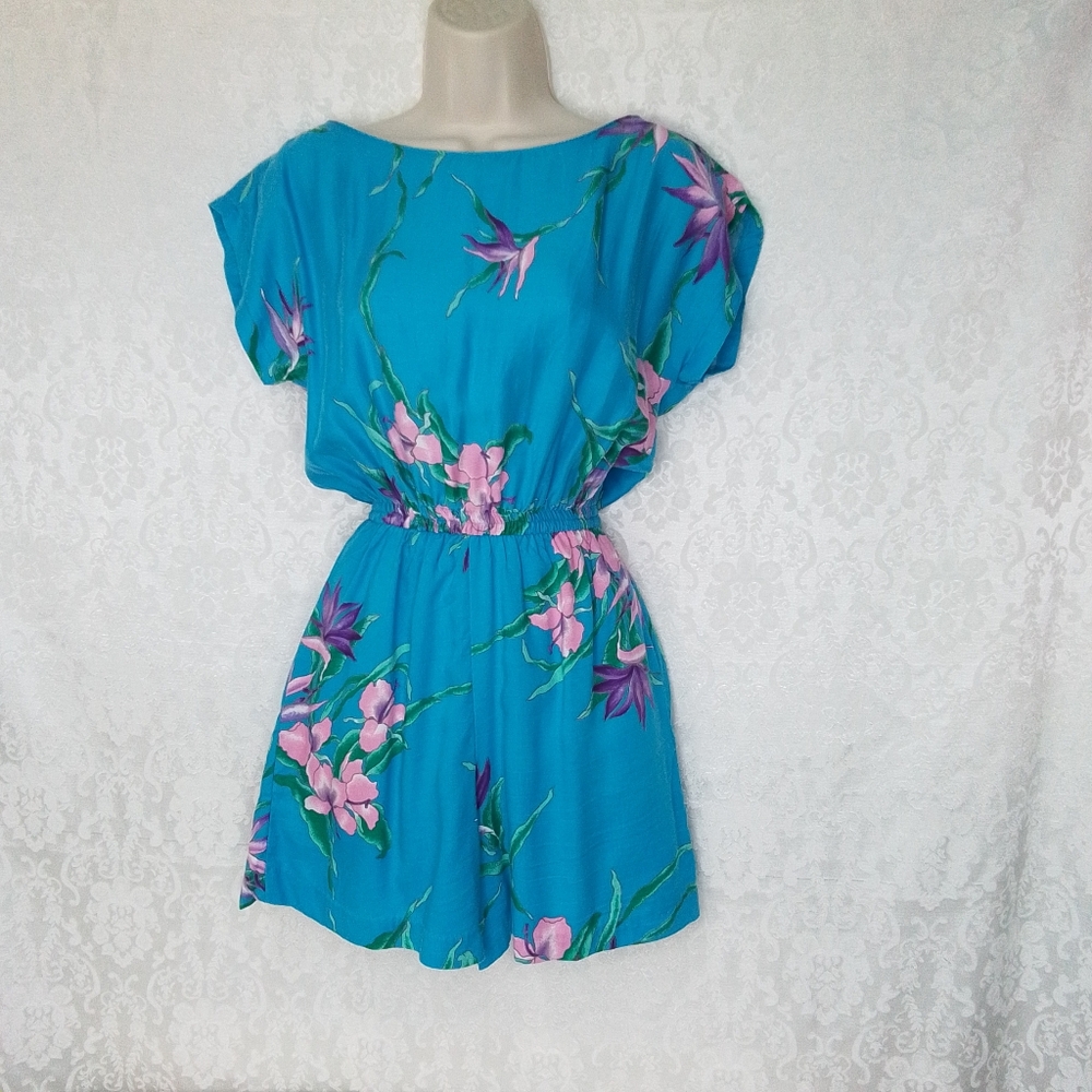 Vibrant blue romper with floral accents sleeveless and V back size small